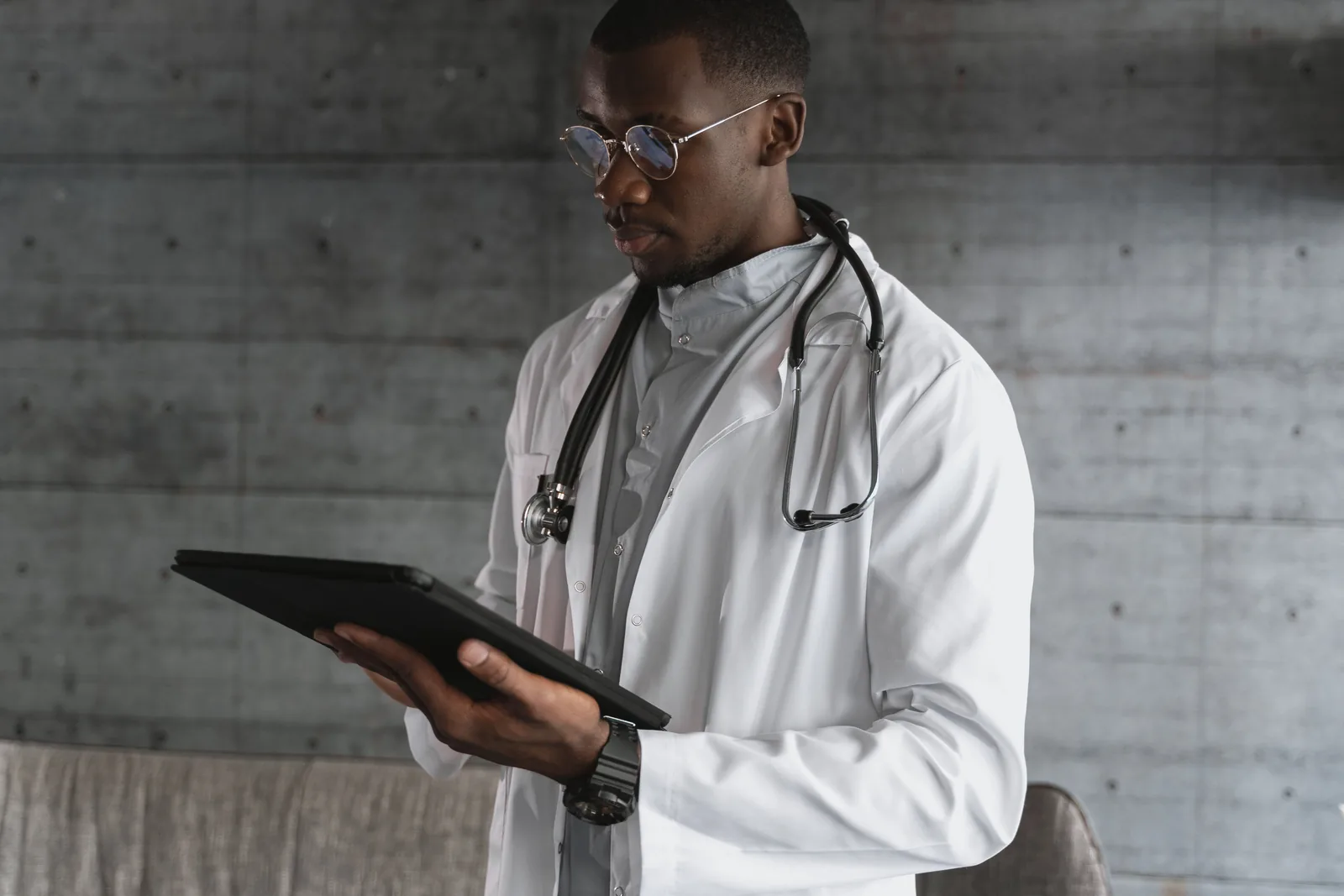 Médico utilizando una tableta para consultar información profesional